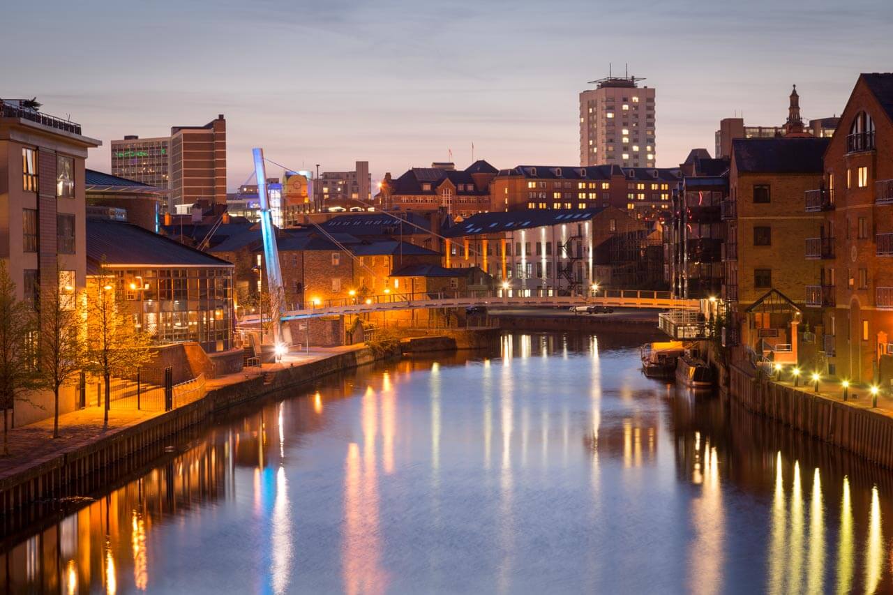 Abendliche Uferpromenade am River Aire in Leeds mit Lichtern im Wasser Vokabeln zur Stadtbeschreibung anwenden im Sprachkurs