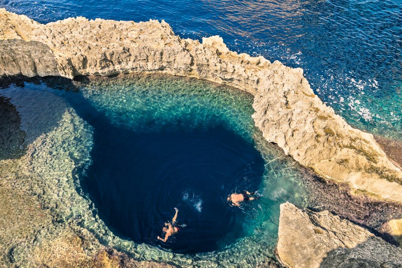 Natürliches Felsbecken mit zwei Schwimmern, Pause nach dem Unterricht. Hörverstehen üben am Wasser.